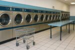 Coin operated laundromat near me with clean modern machines and folding tables