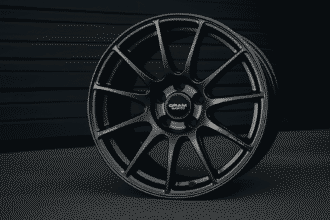 Close-up image of a sleek alloy wheel from Gram Lights placed against a dark background.