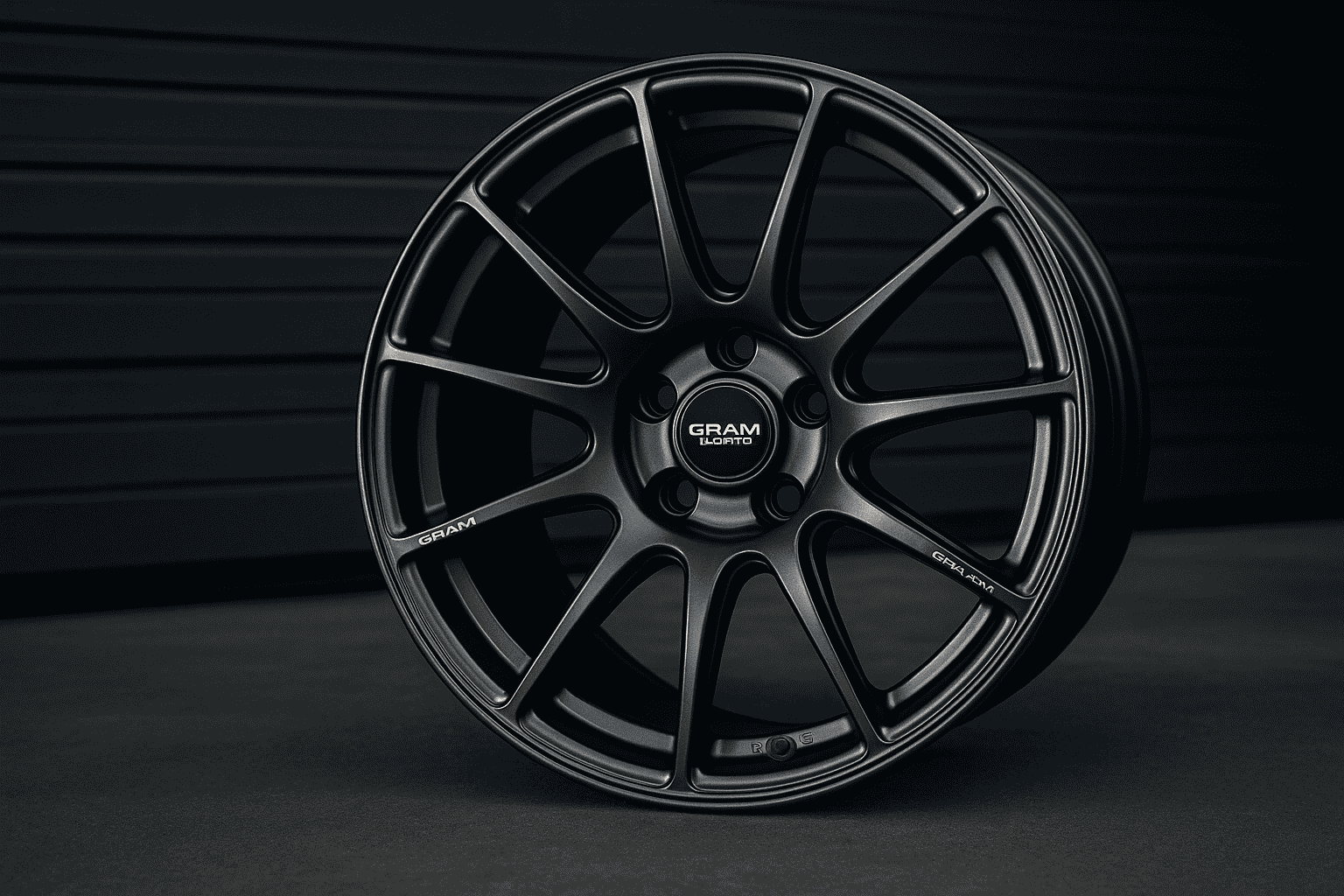 Close-up image of a sleek alloy wheel from Gram Lights placed against a dark background.